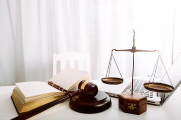 Justice and law concept.Male judge in a courtroom with the gavel, working with, computer and...