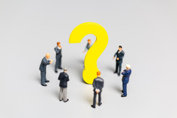 Businessman with big question. workers trying to solve the problem concept