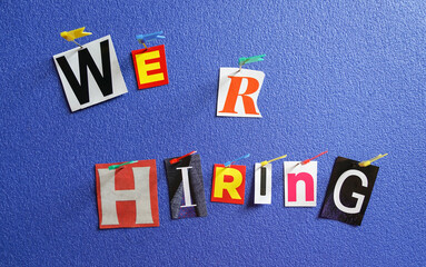 We are hiring, colorful letters cut out from magazine, pin out on board