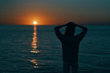 Fototapeta premium female silhouette on the beach near the sea at sunset