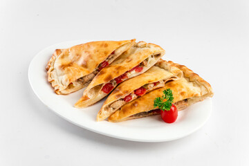 Isolated plate of sliced calzone Italian folded pizza