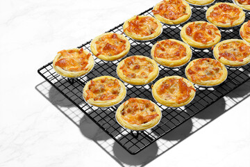 Mini pie from meat and mushrooms in metal tray