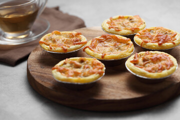 Mini pie from meat and mushrooms in wooden tray