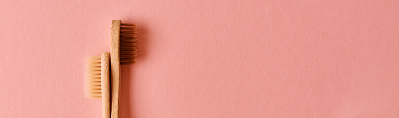 Reusable bamboo toothbrushes on pink background. Zero waste