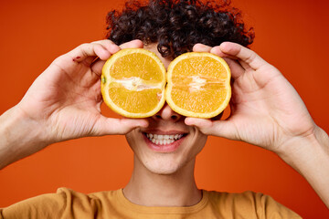 guy with curly hair oranges near face emotions close-up