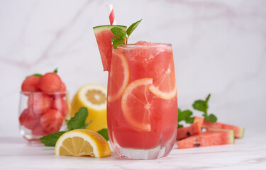 Fresh fruit smoothies, Homemade watermelon lemonade, portrait of summer fresh fruit drink. fruit flavored water mix with lemon, watermelon, mint leaves and ice. detox water cocktail, selective focus.