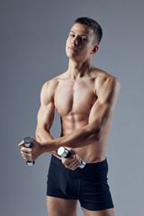 sporty man with dumbbells in hands workout exercises isolated background