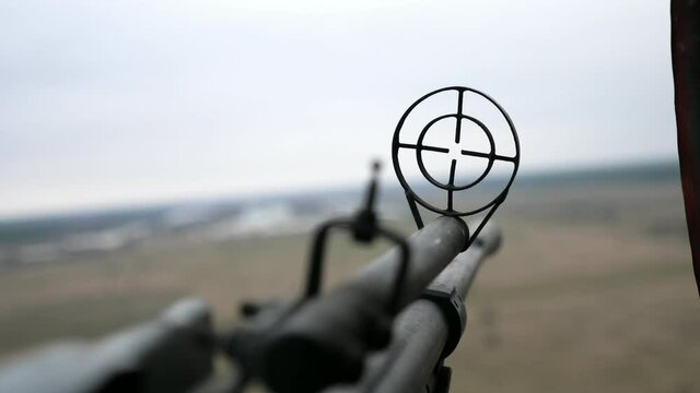 12.7mm machine gun front sight trembling in a soaring helicopter in early spring