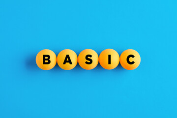 The word basic written on yellow balls