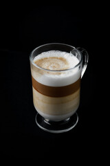Coffee with milk on dark background. Close up. Copy space. 