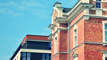 Street art hanging  against modern buildings background. Beautiful colorful ornaments in city. Retro stylized colorful tonal filter effect.