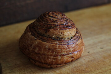 Fototapeta na wymiar fresh baked goods, crumpet from, snail bun, bread roll with poppy seeds and cinnamon