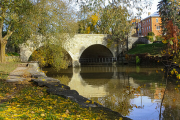 Old bridge over the river in autumn