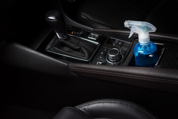 Fototapeta na wymiar Bottle of blue sanitizer ethyl alcohol hand gel cleanser put in the car, prepare for protecting coronavirus, COVID-19 concept