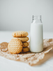 Delicious homemade peanut butter cookies with mug of milk, on white background. Healthy breakfast concept.