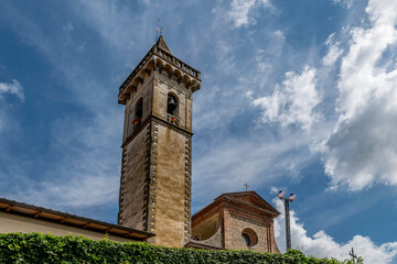 The bell tower and part of the facade of the Santa Croce church in the historic center of Vinci,...
