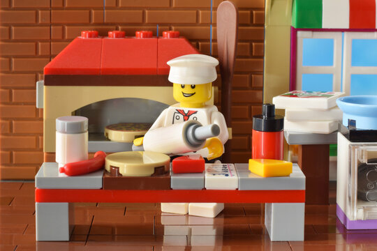 Lego minifigure is cooking pizza in italian cafe. Editorial illustrative image of occupation of cook.