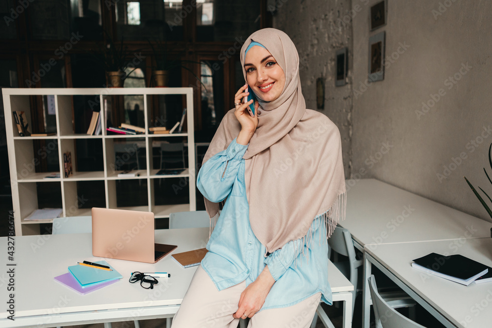 Wall mural muslim woman in hijab working in office room