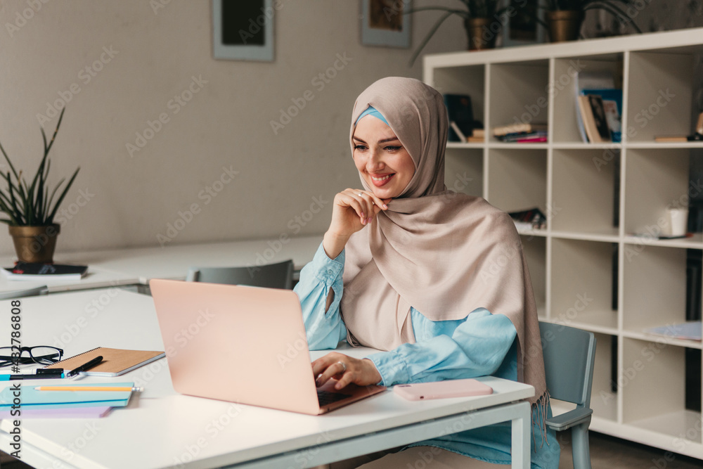 Wall mural modern muslim woman in hijab in office room