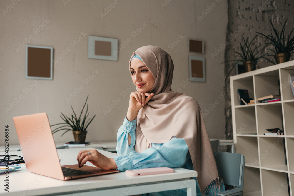 Wall mural modern muslim woman in hijab in office room