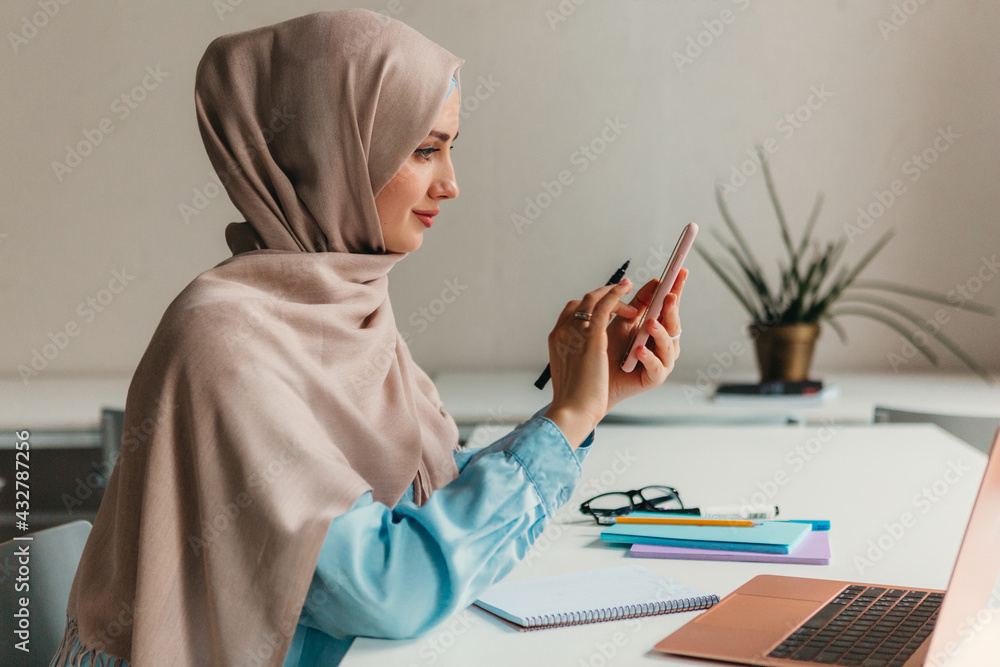 Wall mural modern muslim woman in hijab in office room