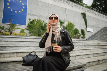 modern stylish muslim woman in hijab in city street