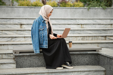 Naklejka premium modern stylish muslim woman in hijab in city street