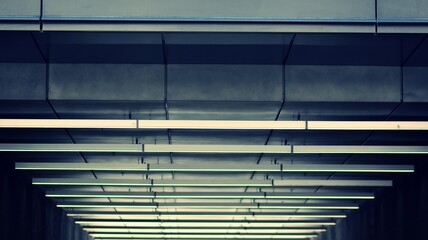 Obraz premium A fragment of the steel and glass metal facade of building. Detail architecture steel and glass facade on clear blue sky background. Modern architecture building facade with balconies. Retro filter.