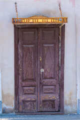 Very old double-leaf door in red-brown color