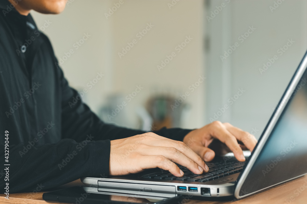 Poster young man using laptop computer and mobile phone when looking for financial information in business,