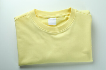 Yellow sweatshirt on white background, space for text