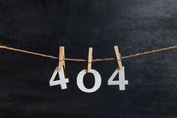 Numbers 404 with clothespins on black background. Error 404. Something wrong. Inscription from...