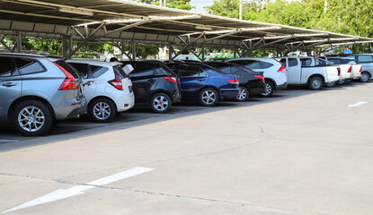 Closeup of rear, back side of blue car with  other cars parking in indoor parking area.