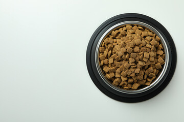 Pet bowl with feed on white background