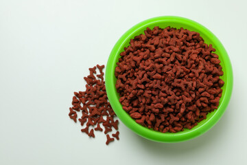 Pet bowl with feed on white background