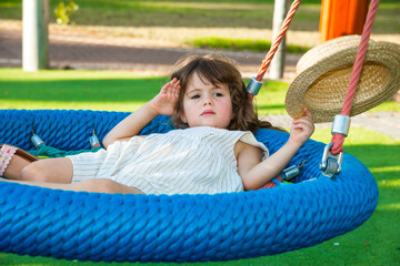 Charming little girl swings