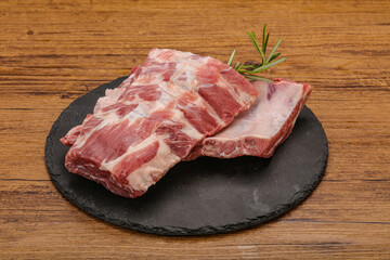 Raw pork ribs served rosemary