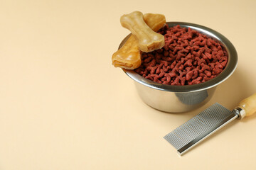 Pet feed and hair brush on beige background