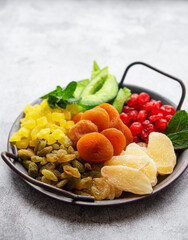 Metal tray with different types of dried fruits