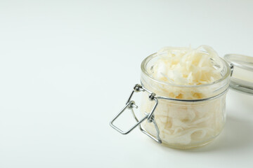 Glass jar of sauerkraut on white background