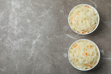 Bowls of sauerkraut on gray textured background