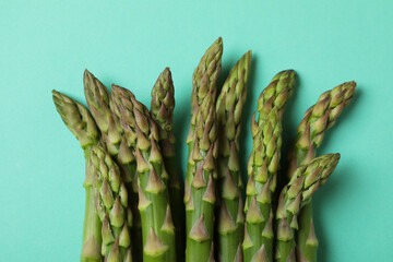 Fresh green asparagus on mint background, close up