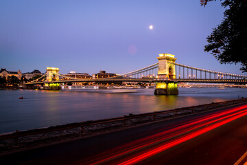 Illuminated Chain Bridge in Budapest with a purlpe sunset