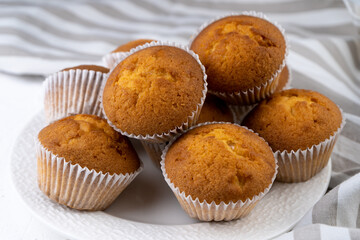 Biscuit muffins close-up. Sweet pastries. Party treat. Dessert on white table - homemade muffins. Portioned cupcakes. Simple muffin
