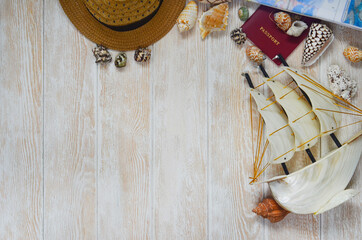 seashells, hat and passport on the table, copy space for text, background for design, vacation, summer and travel concept