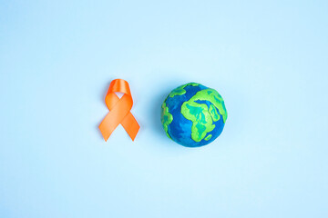 World Multiple Sclerosis Day. Orange awareness ribbon and planet Earth.