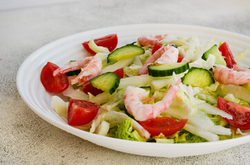 fresh summer salad of peking cabbage, cherry tomato, cucumber and shrimps