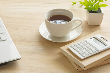A cup of coffee on a wooden desk