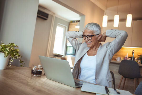 Woman streaching during a break. She work at home. Lady Stretching Hands With Eyes Closed Working Sitting In Office. Break At Work. Taking a short breather during work