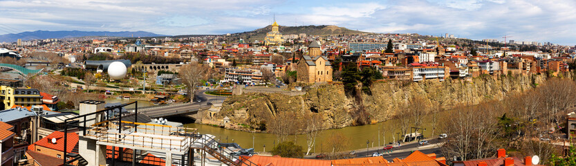 Panorama of historic center of Tbilisi city on banks of Mtkvari River on sunny spring day, Georgia © JackF